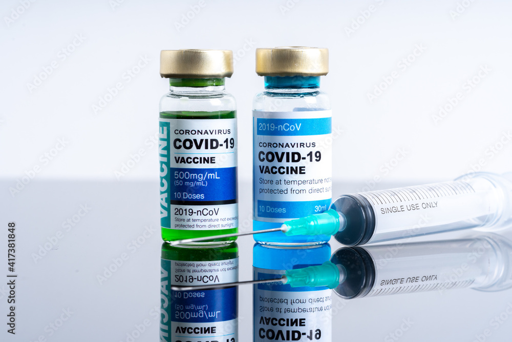 Medical concept ampoules or vials with Covid-19 vaccine on a laboratory bench Medical concept ampoules or vials with Covid-19 vaccine on a laboratory bench