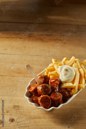 Delicious fried potatoes with sausages in plate