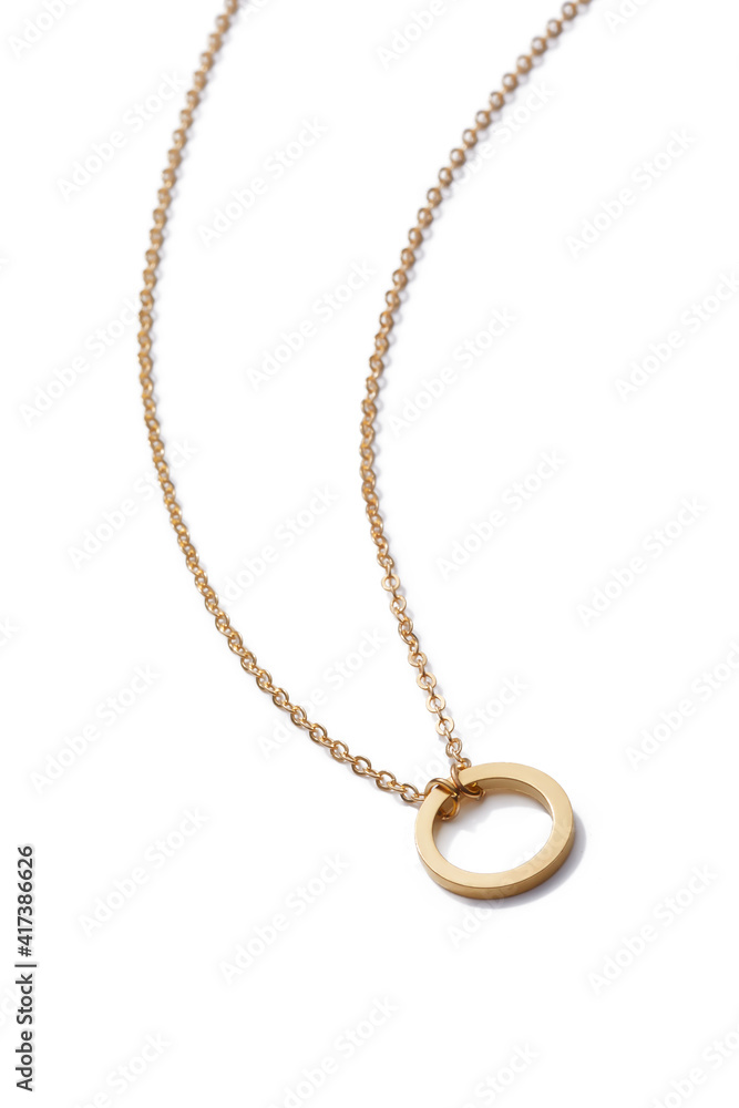 Cropped close-up of elegant golden necklace with flat silver ring. The stylish jewelry is isolated on the white background. Cropped close-up of elegant golden necklace with flat silver ring. The stylish jewelry is isolated on the white background.