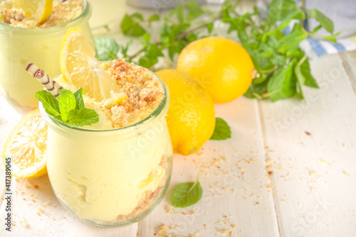 No baked homemade lemon cheesecake with mint in small vintage jars