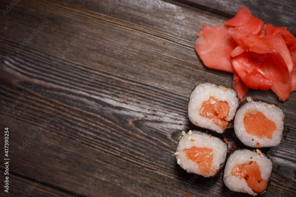 sushi rolls with seafood on a wooden table and chopsticks sushi rolls with seafood on a wooden table and chopsticks