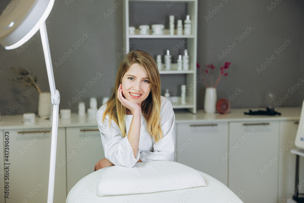 Consultation in cosmetology clinic. Female beauty doctor in white coat smiling. Healthcare concept. Consultation in cosmetology clinic. Female beauty doctor in white coat smiling. Healthcare concept.