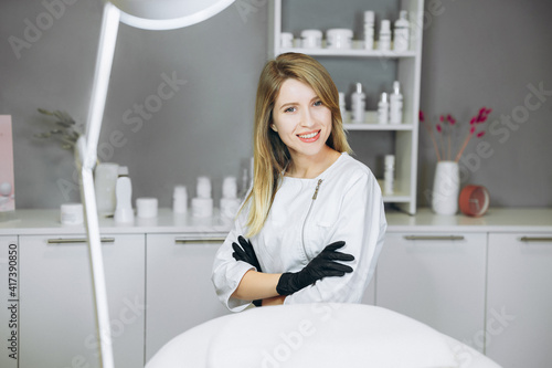 Consultation in cosmetology clinic. Female beauty doctor with black gloves on her hands. Healthcare concept.