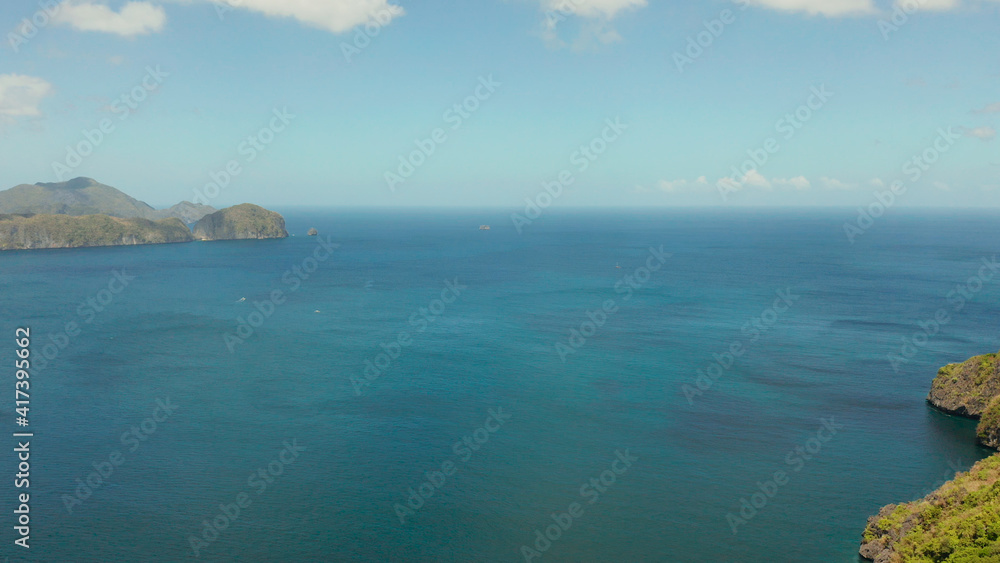 Aerial drone of Seascape with tropical rocky islands, blue water. islands and mountains covered with tropical forest. El nido, Philippines, Palawan Aerial drone of Seascape with tropical rocky islands, blue water. islands and mountains covered with tropical forest. El nido, Philippines, Palawan