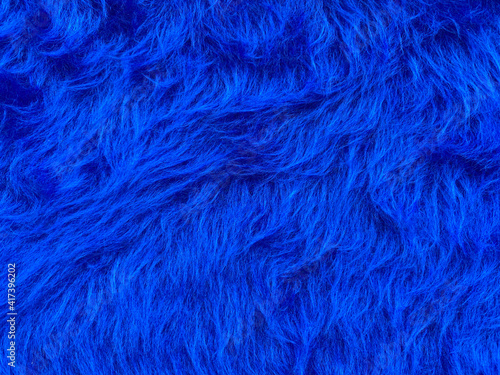 Close up abstract Fluffy Navy Blue wool texture and background, cotton wool. Fashionable color.Decorative dyed sheepskin with copy space.