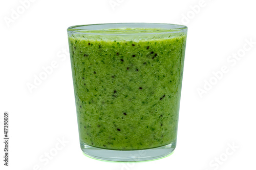 green smoothie of kiwi banana and spinach in a glass on a white background closeup