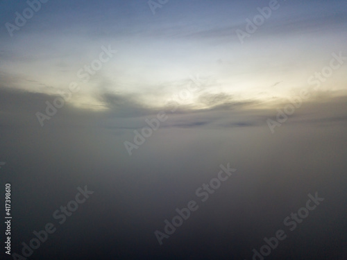 High flight above the clouds at sunset. Aerial view. © Sergey