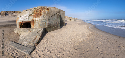 Old concrete bunkers from WWII line the beaches on the west coast of Denmark. The bunkers are part of The Atlantic Wall that was an extensive system of coastal defence and built by Nazi Germany. photo