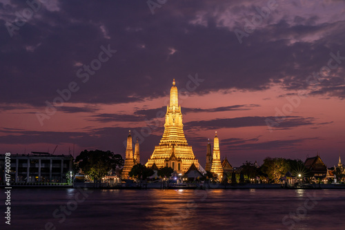 Wat Arun Temple beside Chao Phraya River at twilight time in Bangkok, Thailand. One of the most famous place of Thailand's landmarks.