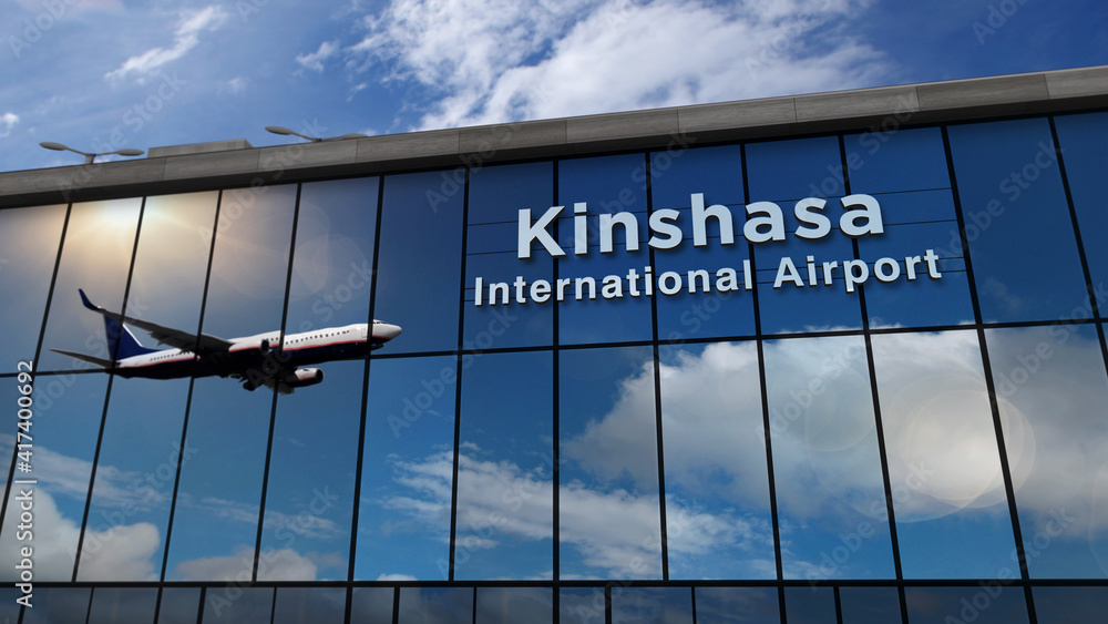 Airplane landing at Kinshasa Congo airport mirrored in terminal Stock