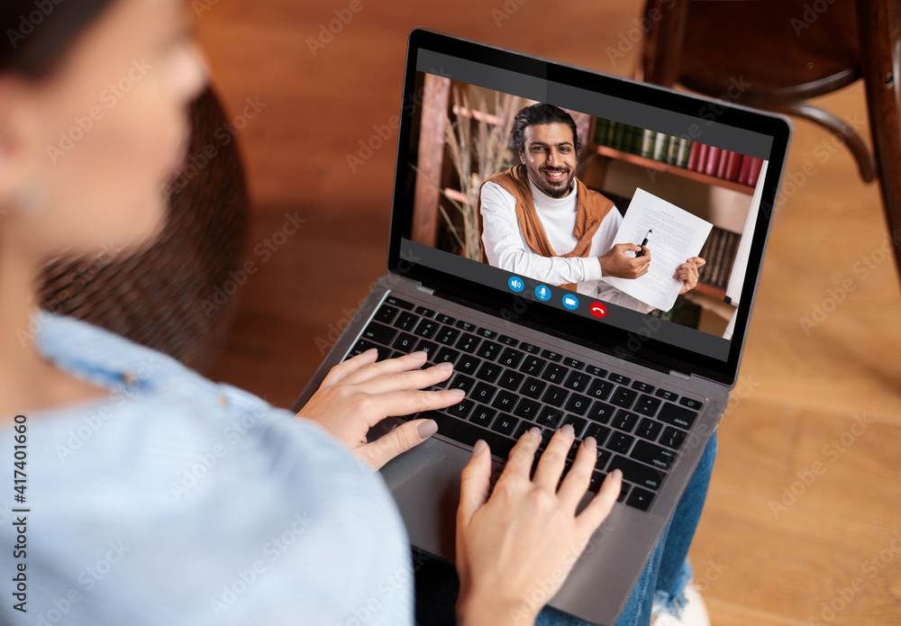 Woman using laptop having video chat with teacher Woman using laptop having video chat with teacher