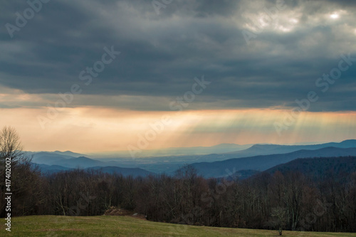 dramatic sun rays peaking through the clouds in Shenandoah National Park in Virginia during early spring.