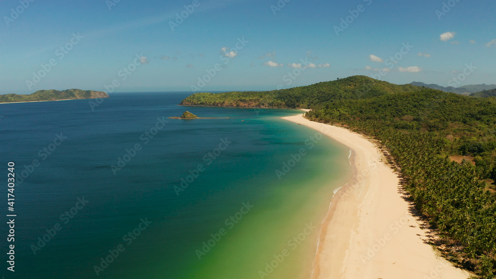 Tropical island with sandy beach, aerial view. Nacpan, El Nido, Palawan, Philippine Islands. Seascape with tropical beach and islands. Summer and travel vacation concept