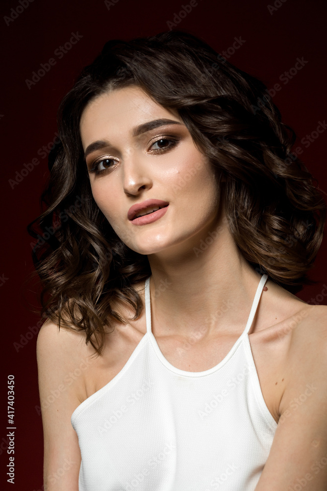 close-up portrait of a beautiful exquisite brunette girl on a red studio background in a white dress close-up portrait of a beautiful exquisite brunette girl on a red studio background in a white dress