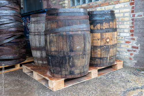 Vintage wooden barrels on a pallet in an industrial setting in urban Chicago