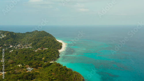 The famous tropical island of Boracay with white beach, hotels among the forest, aerial view. Summer and travel vacation concept.