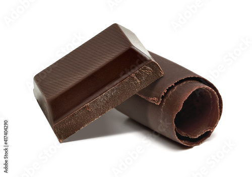 Broken or cracked dark chocolate tablet or bar with curl isolated on white background with clipping path