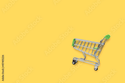 shopping trolley isolated on yellow background with copy space. clipping paths.