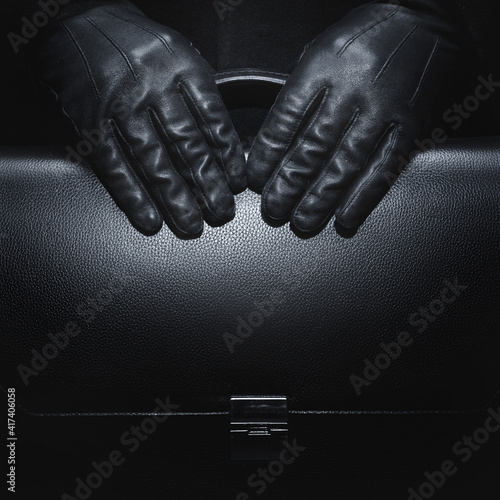 Black leather gloves. Briefcase in black leather. Business style. photo