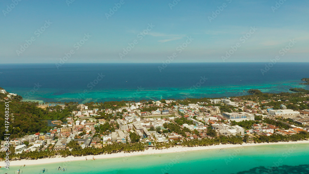 Aerial view of beautiful bay in tropical Island with white sand beach Boracay, Philippines. White beach with tourists and hotels. Tropical white beach with sailing boat.