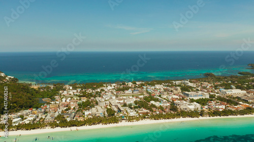 Aerial view of beautiful bay in tropical Island with white sand beach Boracay, Philippines. White beach with tourists and hotels. Tropical white beach with sailing boat. © Alex Traveler