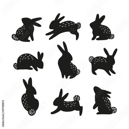 Folksy Easter bunny black silhouette collection. Rabbit with furry ornament clipart set isolated on white background. Folk art hare animal shape design elements.