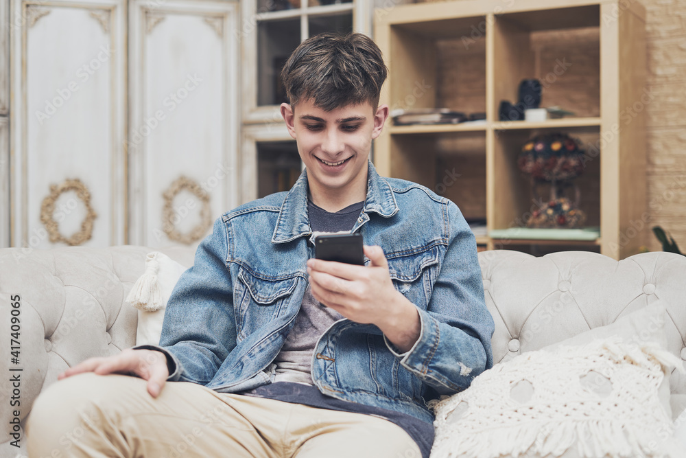 Happy guy with phone at home Happy guy with phone at home