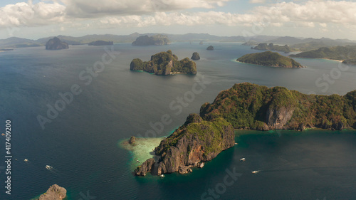 Cove with lagoons and the tropical islands, aerial view. Seascape with tropical rocky islands, ocean blue water. islands and mountains covered with tropical forest. El nido, Philippines, Palawan