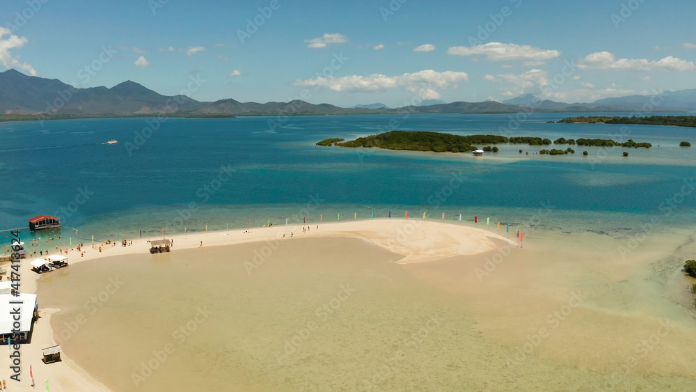 Obraz premium Beautiful beach on tropical island surrounded by coral reef, sandy bar with tourists. honda bay top view. Luli island. Summer and travel vacation concept, Philippines, Palawan