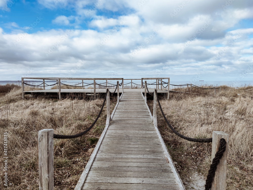 Photo of wooden pier with observation deck entering the sea in north Germany on Baltic sea