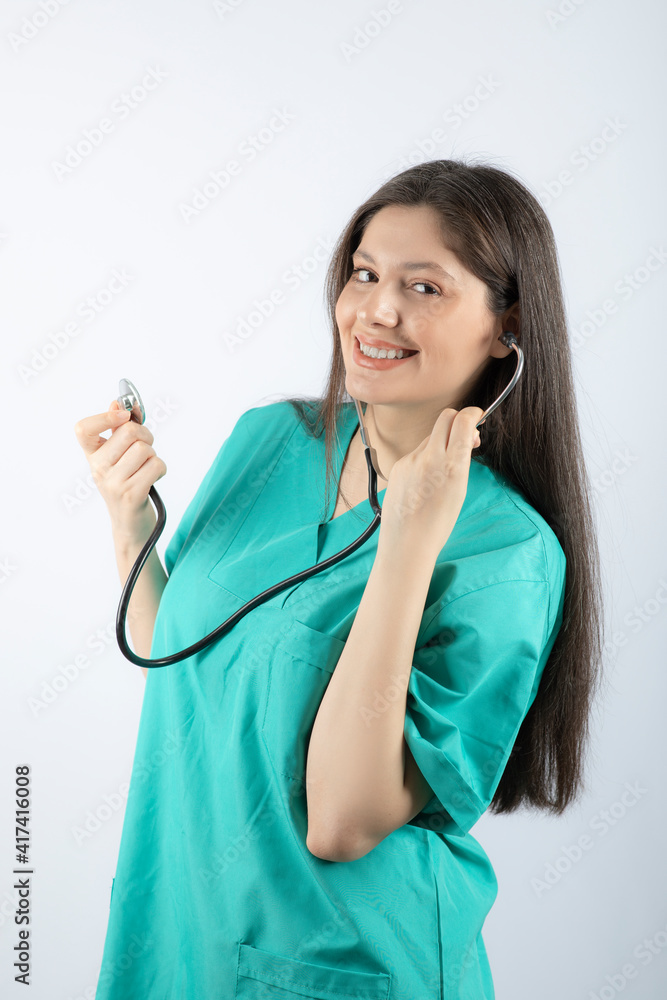 Portrait of a young woman doctor with stethoscope in uniform. Portrait of a young woman doctor with stethoscope in uniform.