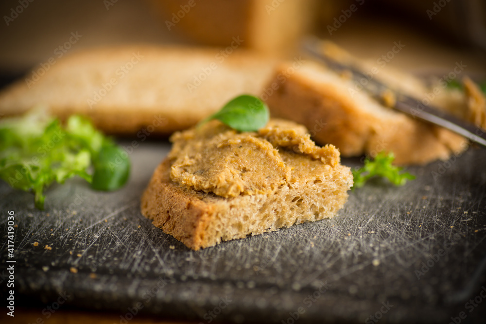 homemade meat pate with bread on a wooden table homemade meat pate with bread on a wooden table
