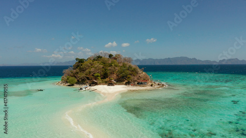 aerial seascape tropical island and sand beach, turquoise water and coral reef. malacory island, Philippines, Palawan. tourist boats on coast tropical island.