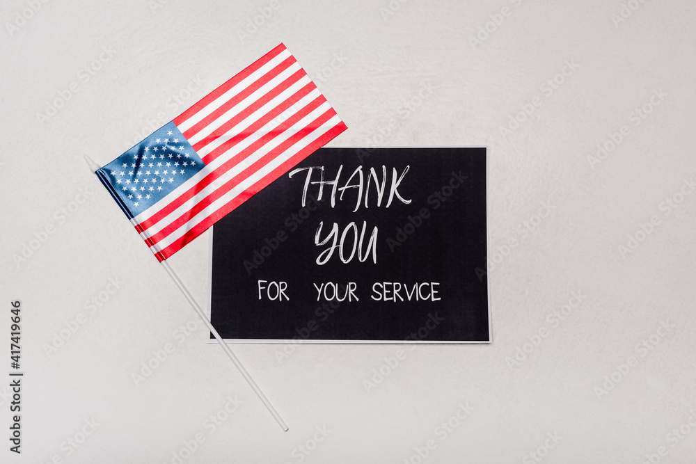 Top view of American flag near card with thank you for your service ...