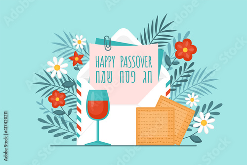 Passover holiday concept with envelope, matzah. wine glass and flowers. Text in Hebrew: "Happy Passover"