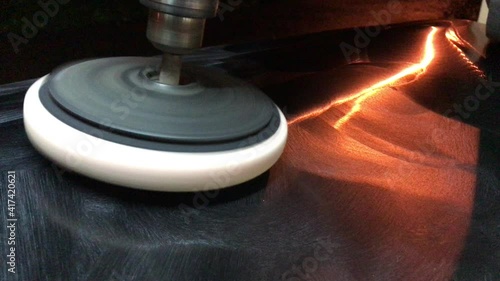 Processing of the paint surface of the car with a polishing wheel.