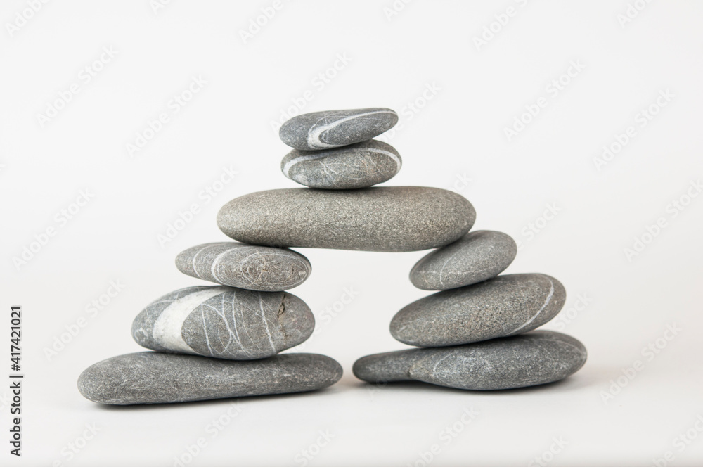 Pyramid of sea pebbles on white background. Life balance and harmony concept Pyramid of sea pebbles on white background. Life balance and harmony concept