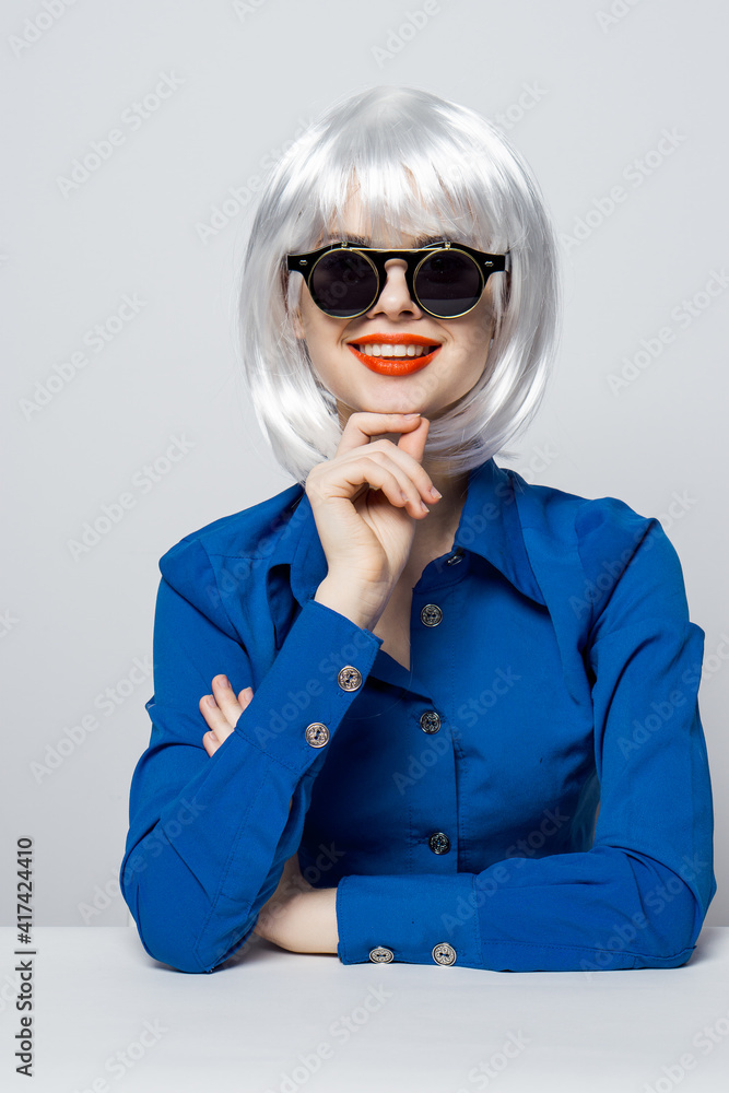 attractive woman in white wig sunglasses red lips glamor blue shirt isolated background attractive woman in white wig sunglasses red lips glamor blue shirt isolated background