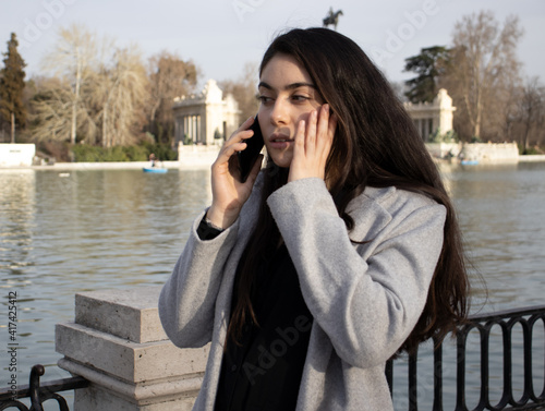 woman worried while talking on mobile. (receiving bad news) photo