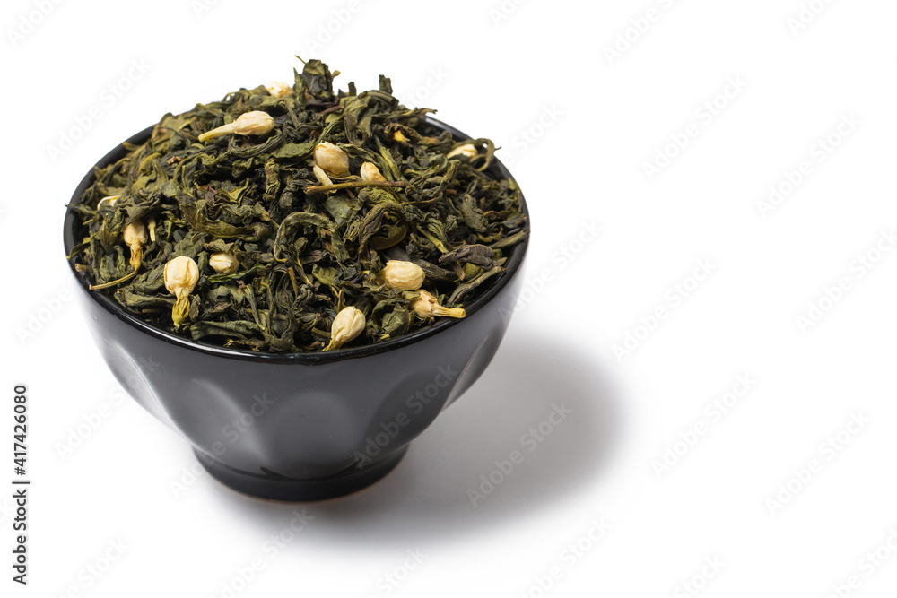 Green tea with jasmine flowers on black background