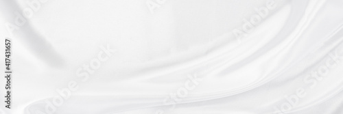 White gray satin texture that is white silver fabric silk panorama background with beautiful soft blur pattern natural.