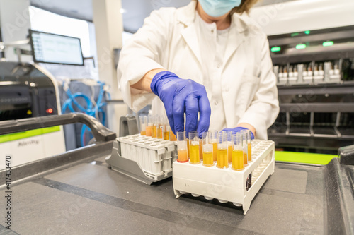 woman in laboratory doing tests for vaccine blood extraction and analytical photo