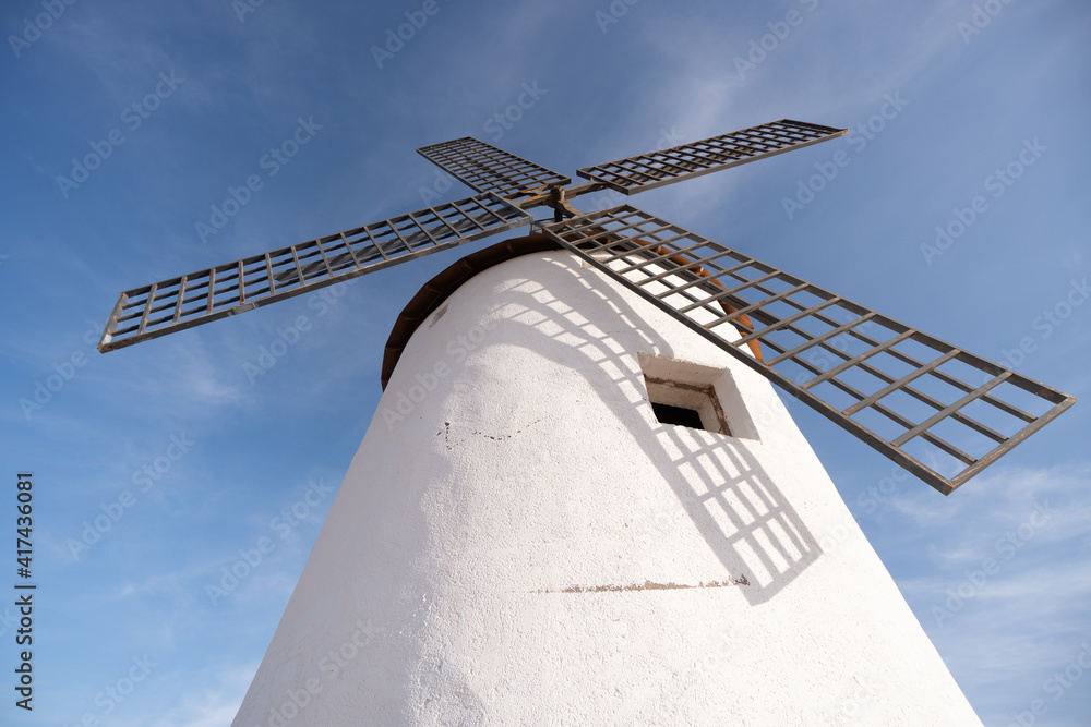 old white windmill from castile la mancha in spain europe don quixote blue sky