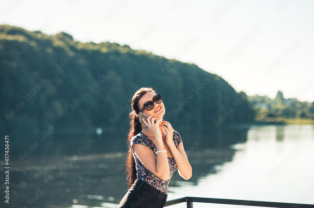 Sexy girl talking on the phone in the park