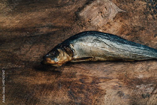 dried fish lies on a wooden table top view texture background image photo