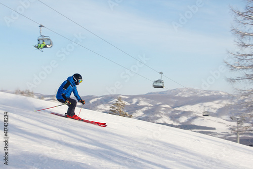 Skier skiing downhill in mountains