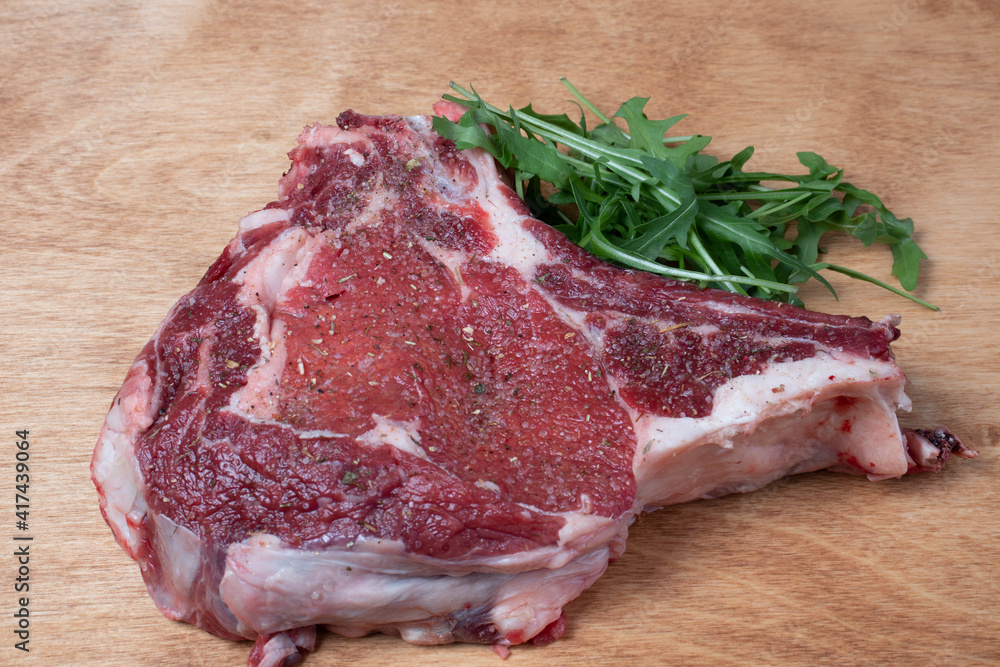 beef steak on a wooden board with greens beef steak on a wooden board with greens