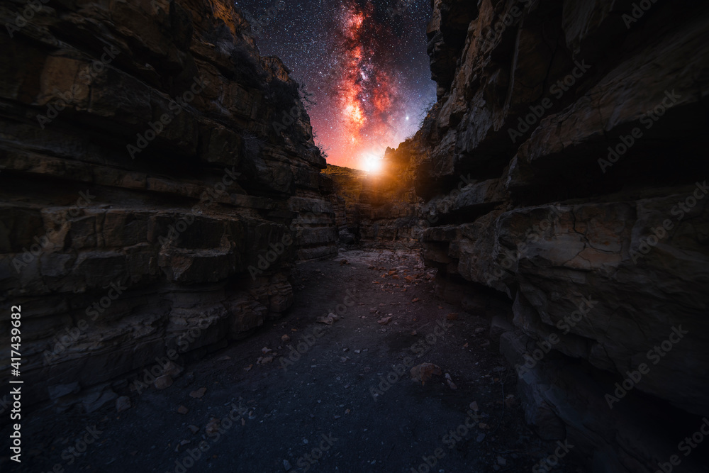 Beautiful night landscape. Red canyon at the starry night with bright bright milkyway galaxy.