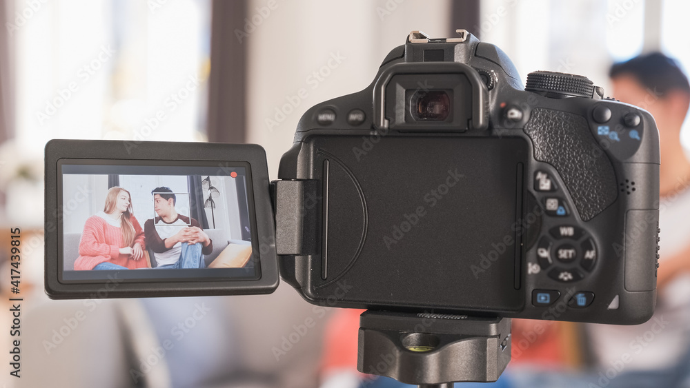 Young couple talking to camera on screen. Woman and man recording a video blog