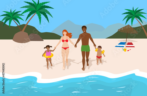 Young happy family on vacation at the beach